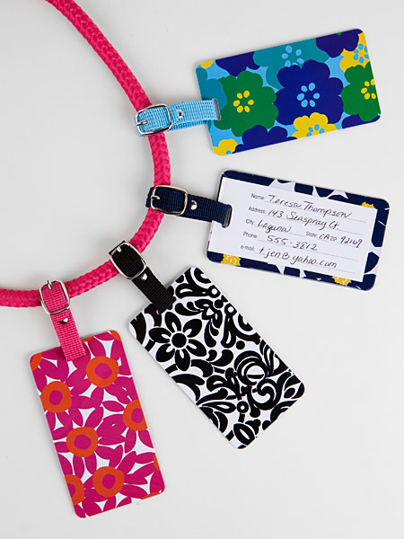 Printed plastic luggage tags featuring: sturdy colored webbing straps and paper ID card with clear plastic covering