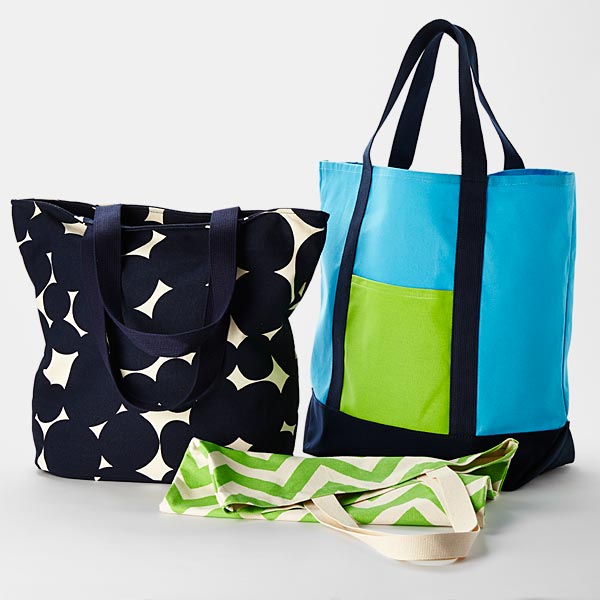 Heavy canvas tote bags feature pockets and zippered tops.