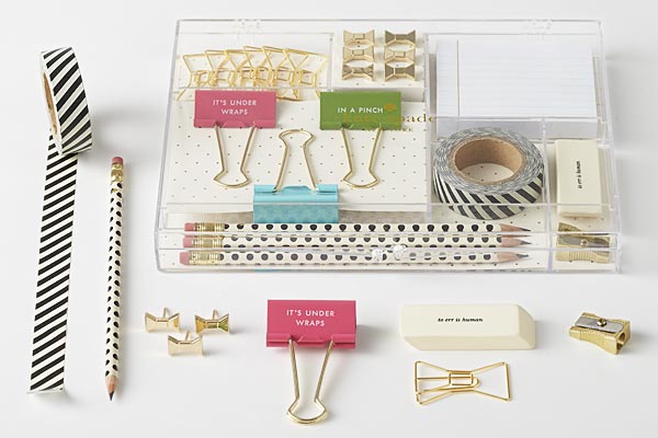 Sleek, acrylic organizational tacklebox with desk accessories:  Bridge pencils, multi-colored binder clips, erasers, patterned washi tape, lined sticky notes, gold electroplated push pins, paper clips, and pencil sharpeners.